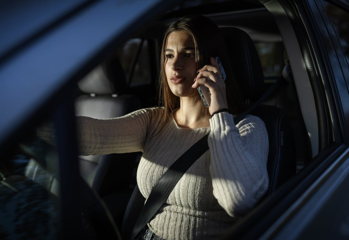 A driver talking on the phone from inside a car